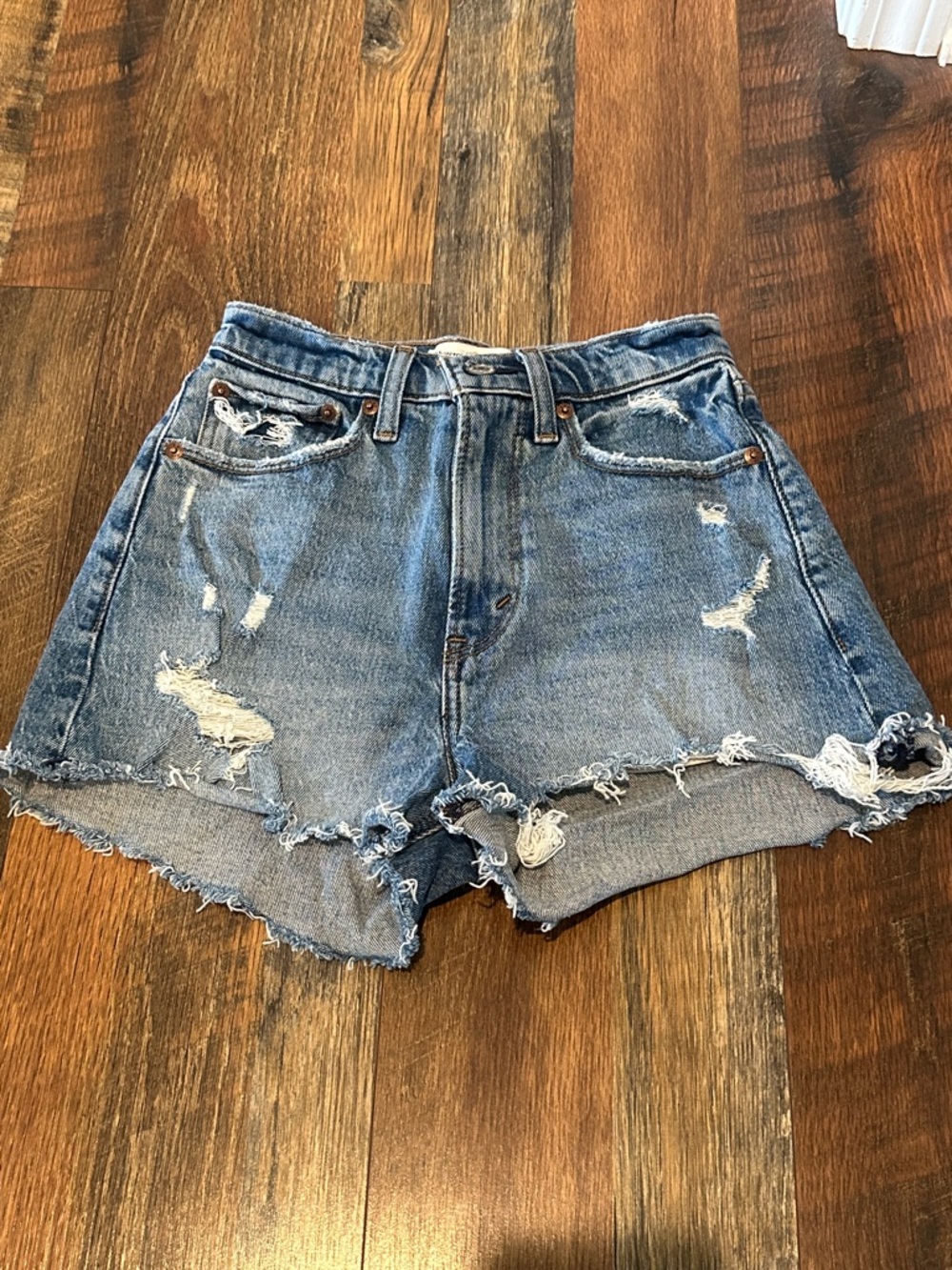 High-Rise Distressed Denim Shorts — Blue